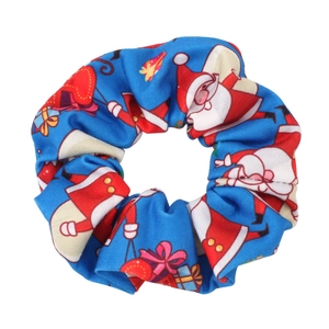 Close-up of royal blue satin Christmas scrunchie with Santa and gift prints