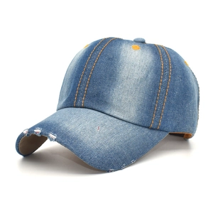Distressed blue denim baseball cap with vintage ripped brim and yellow contrast stitching