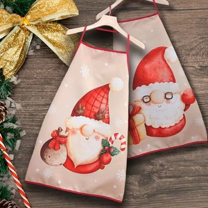 Christmas aprons with Santa and gnome prints on a rustic wood holiday background