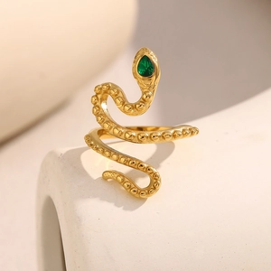 Close-up of golden snake ring with green teardrop stone and textured scales detail