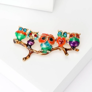 Colorful enamel owls on branch brooch with crystal accents in gold-plated finish
