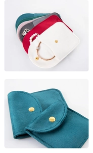 Close-up of velvet jewelry pouches in multiple colors with secure metal snap buttons