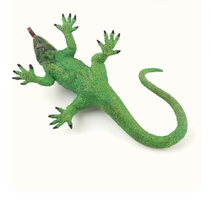 Detailed top view of realistic green lizard toy with spotted skin texture and black claws