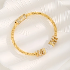 Gold-plated twist cuff bracelet with elegant white pearls and micro-pave cubic zirconia