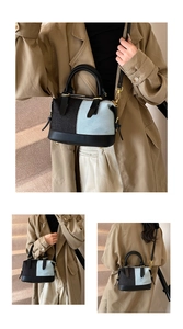 Detailed view of the patchwork denim Boston bag with gold hardware and shoulder strap