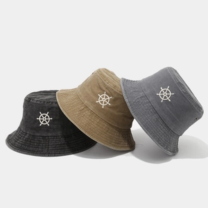 Three washed cotton bucket hats with nautical helm embroidery in black, khaki and grey