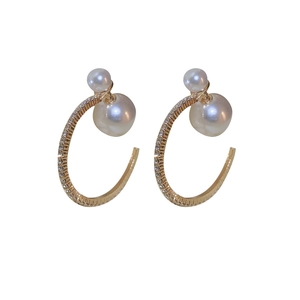 Elegant gold C-shaped hoop earrings featuring pearls and sparkling diamond accents