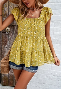 Detail of square neckline and ruffled sleeves on yellow floral tiered top with smocking