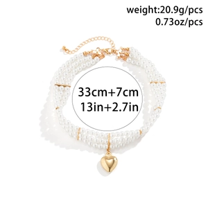 Detailed view of triple-layer pearl choker with gold heart pendant and size specifications