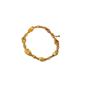 Adjustable gold beaded bracelet featuring textured irregular nuggets and lobster clasp