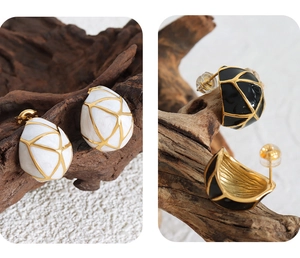 Detail of vintage geometric earrings with enamel finish and gold cross-line patterns