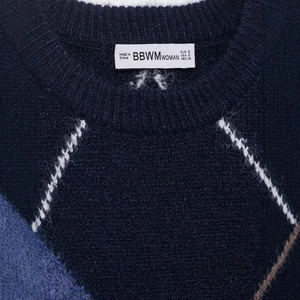 Women's casual navy blue knit sweater with argyle pattern and classic crew neck detail