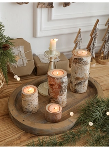 Set of four natural birch wood candle holders in varying heights for holiday table decor
