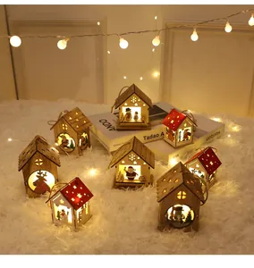 Close-up of wooden Christmas cabin ornaments with LED warm lights and reindeer patterns