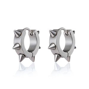 Macro detail of punk rock style stainless steel hoop earrings with sharp silver spikes