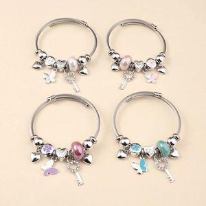 Detail of four colorful charm bracelets featuring heart charms and enamel floral beads