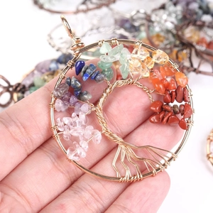 Macro shot of handmade copper wire tree of life pendant with colorful natural stones