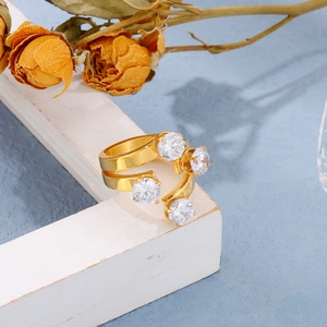 18K gold plated stainless steel open ring featuring four round claw-set white crystals