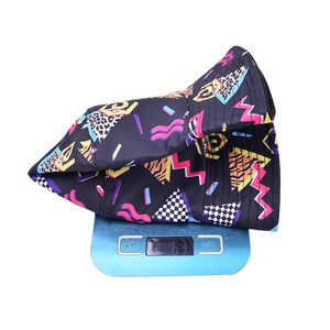 Detailed view of 63g graffiti bucket hat on digital scale showing light weight