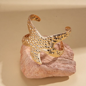 Macro view of golden starfish open cuff bracelet with detailed realistic sea texture