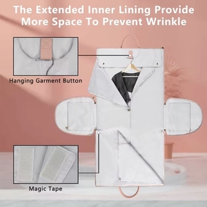 Detail of travel garment bag featuring hanging button and velcro strap on white fabric