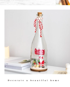 Miniature Christmas scene with Santa and tree inside a glass bottle for home decor