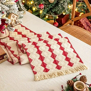 Christmas table runner with red and white geometric patterns and tassel edges for holiday decor