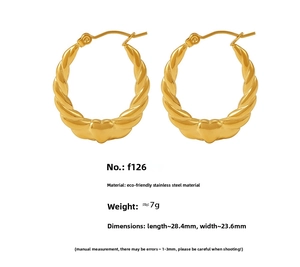 Detail view of 18K gold plated stainless steel heart hoop earrings with twist texture