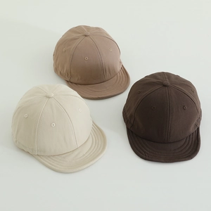 Detailed top view of child short brim cotton canvas baseball caps in three earthy colors