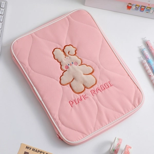 Detailed embroidery of a cartoon rabbit on a quilted pink 11-inch tablet sleeve