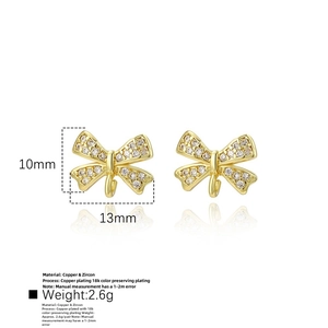 Detailed view of 18k gold plated copper bow earrings with micro-pave cubic zirconia
