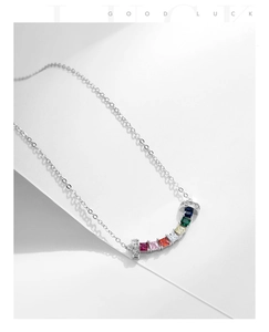 Macro shot of curved rainbow zirconia pendant necklace with sterling silver chain