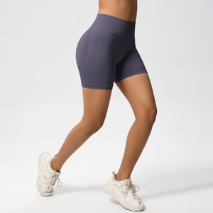 Detail showing high-waisted seamless fitness shorts with peach lift effect in deep purple