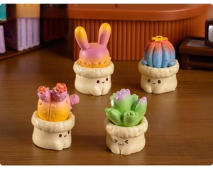 Set of four cute miniature succulent figurines with smiling pot bases for desktop decor