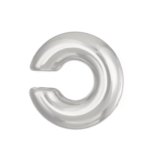 Close-up of polished silver C-shaped ear cuff with smooth metallic finish and minimalist design