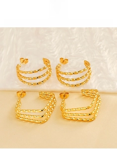 Detailed macro view of 18k gold plated titanium steel twisted triple layer earrings