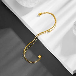 Double-layered gold titanium steel bracelet with sparkling zircon on a stone platform