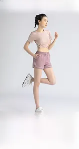 Detail of high-waist elastic sports shorts with white trim and waist drawstring