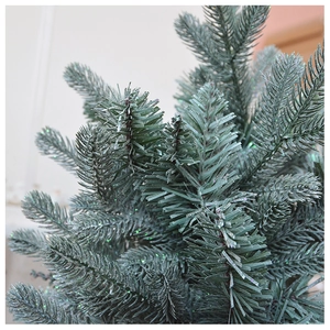 Close-up of artificial pine needles with shimmering glitter coating for Christmas tree