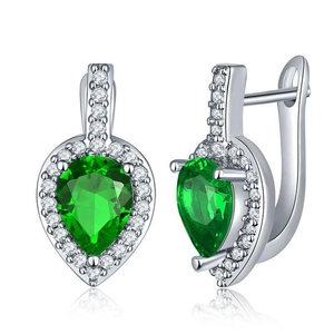 Macro view of pear-cut green zircon earrings with silver-plated halo setting