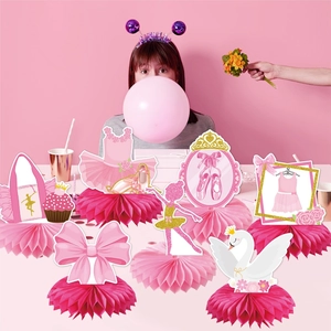 Pink ballet themed party decorations featuring swan, tutu, and dancer honeycomb centerpieces