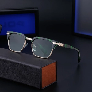 Detail of half-frame sunglasses with green marble pattern and metal cross relief on temple