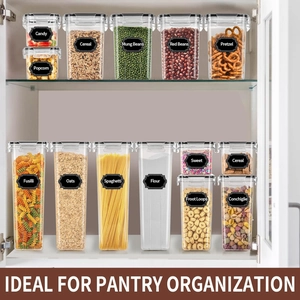 Detail of multi-size transparent food storage containers with black lids in white cabinet