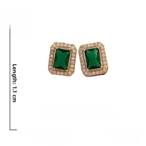 Detailed view of emerald green rectangular stud earrings with silver pins and rhinestones