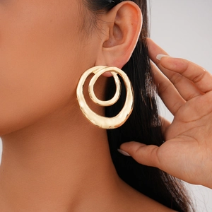 Close-up of model wearing gold double-layer hammered hollow circular drop earrings