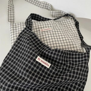 Detailed view of the woven fabric texture and check pattern on canvas tote bags