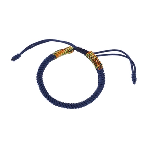 Detailed view of dark blue braided cord bracelet with adjustable knot and colorful accents