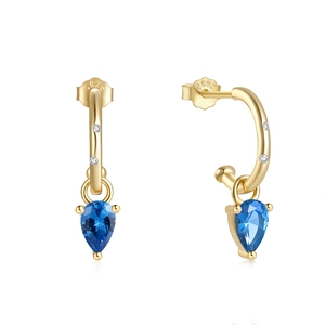Close-up of S925 sterling silver gold-plated earrings with blue pear-shaped drop stones