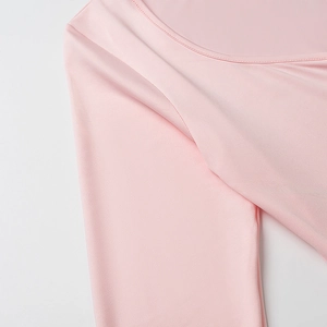 Close-up of pink knit dress neckline showing smooth elastic fabric texture and fine stitching