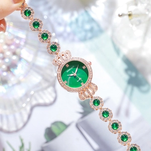 Elegant rose gold women's watch with green sunray dial and gemstone inlaid bracelet